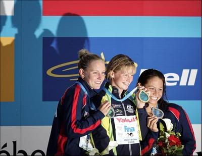 DAustralian swimmer Leisel Jones(C), US swimmer Tara Kirk (R) and Jessica Hardy show their medals on the podium following the women's 100m breaststroke final at the 11th FINA World Championships pic<br />