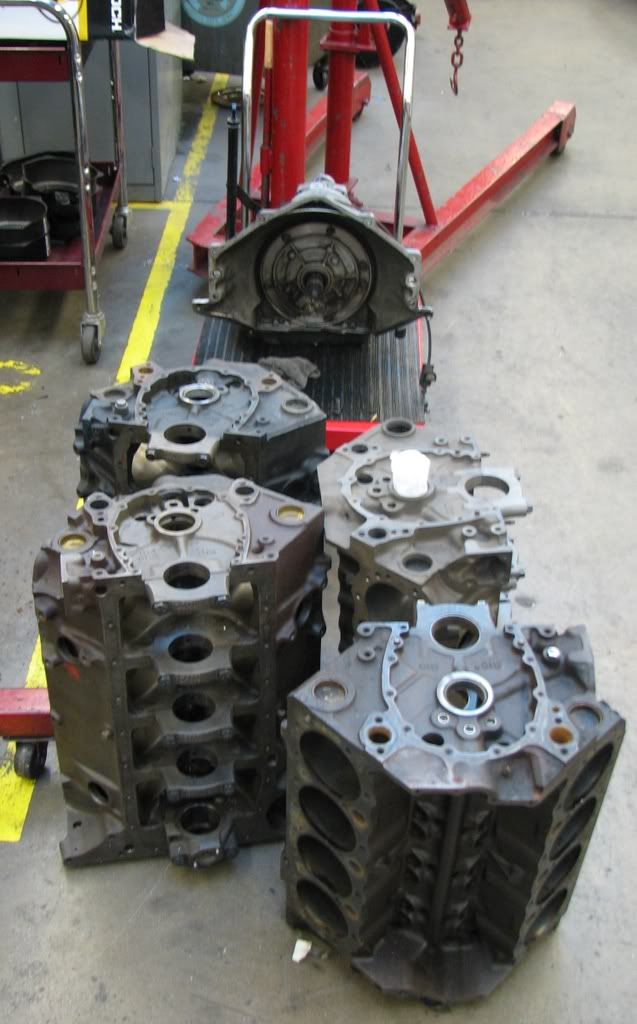 EngineInstall006.jpg Tranmission waiting near some engine blocks image by Marroweter
